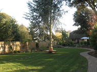 View from house showing new lawn, path and circular seat